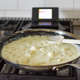 Saute pan on stovetop beside Nintendo DS
